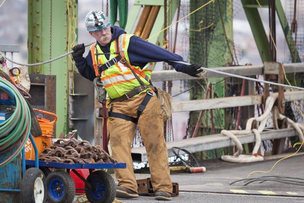 A worker maneuvers cable on the Macdonald Bridge.