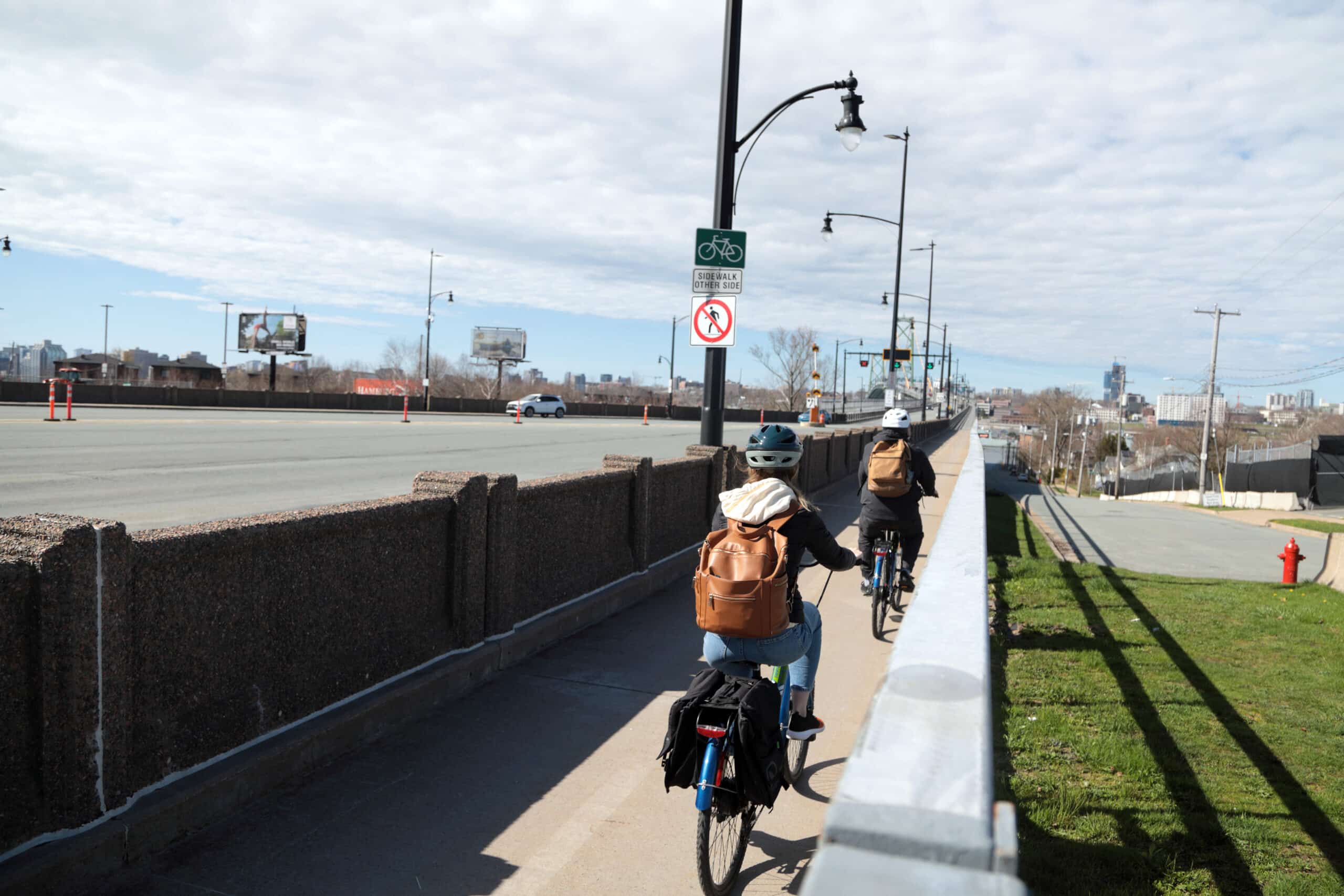 Cyclists ride their bikes in the Macdonald Bridge bike lane.