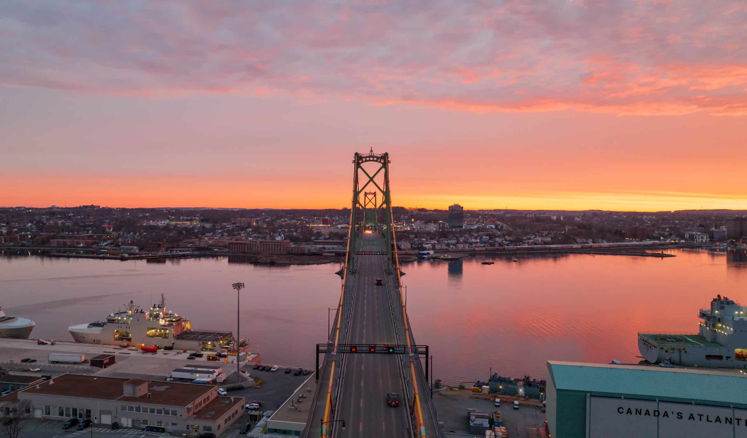 The Macdonald Bridge, with Dartmouth in the background, is seen at sunset.
