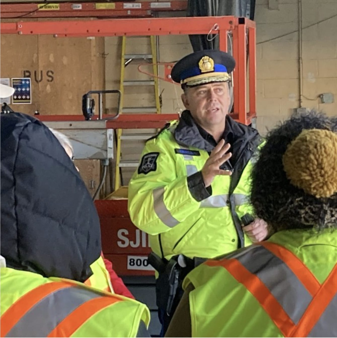 A police officer speaks to people in the Macdonald Bridge garage.