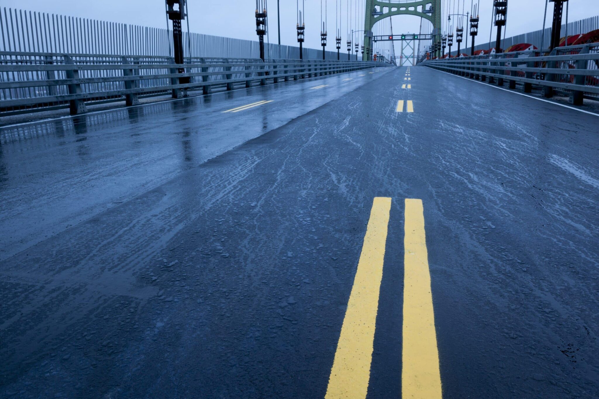 Bright lines are seen painted on the empty, rain-soaked deck of the Macdonald Bridge.
