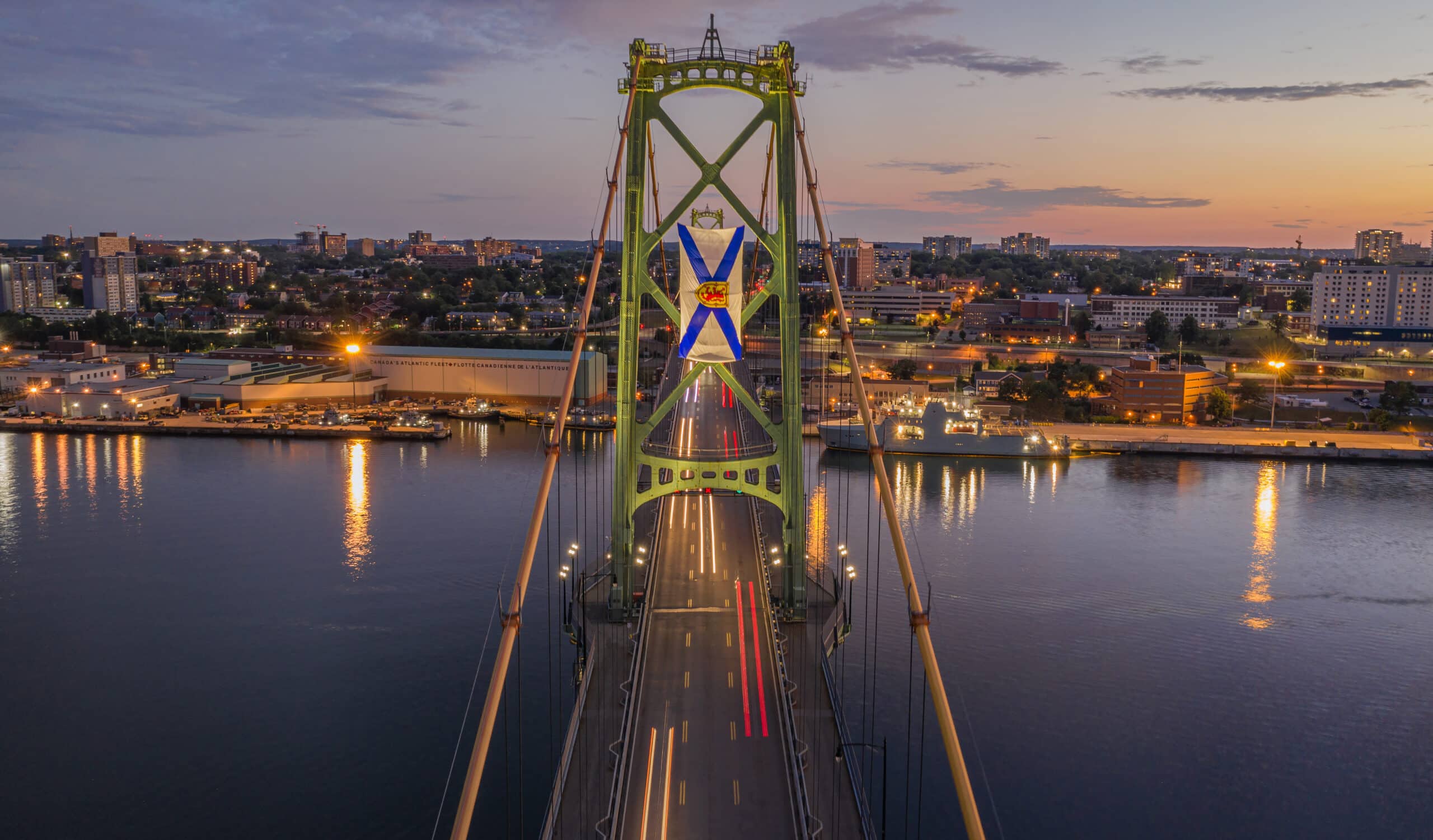 A photo of the Macdonald Bridge Dartmouth tower with the Nova Scotia flag flying.