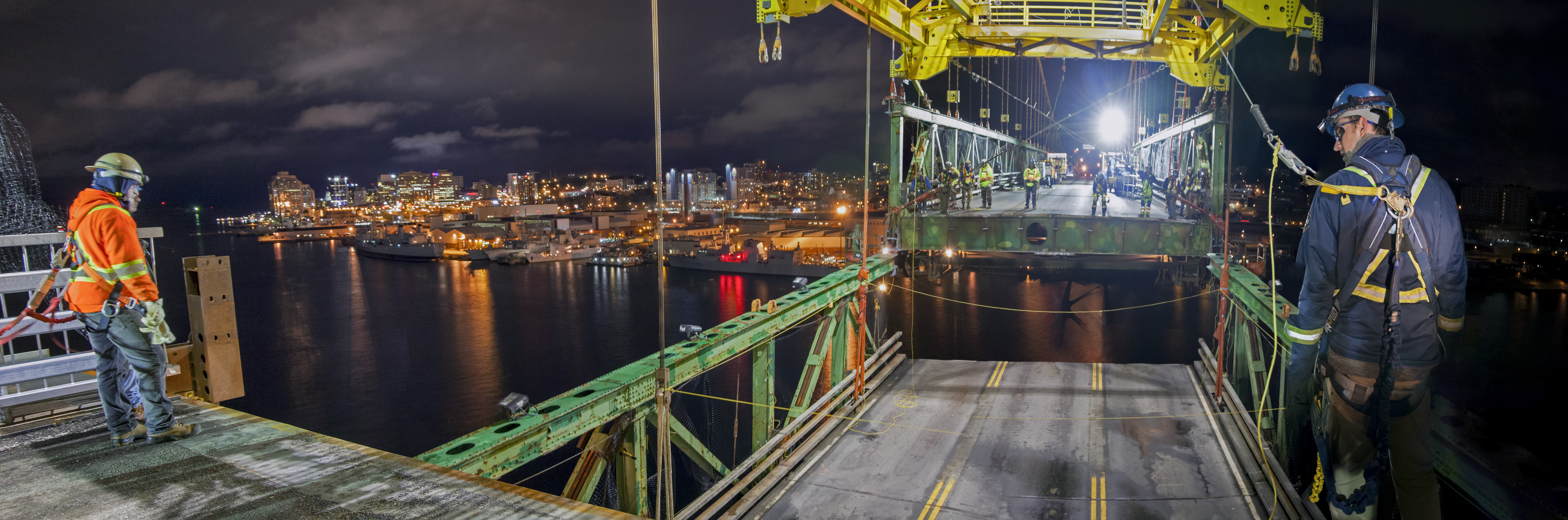 Workers watch a deck segment be raised into place on the Macdonald Bridge during the Big Lift.